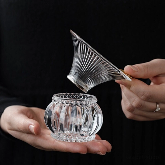 elegant glass loose leaf tea strainer with gold accents for tea rituals