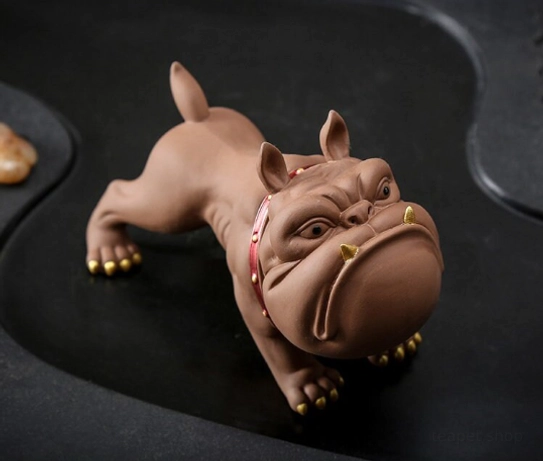 Studio front view of standing French bulldog zisha tea pet on neutral gray background