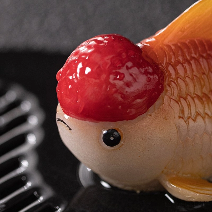 Color changing goldfish tea pet placed on traditional Gongfu tea table as decor