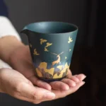 full view of green ceramic gong dao bei tea pitcher with gold deer pattern