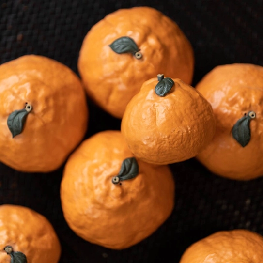 Group of orange tea pets arranged for bulk gifting display