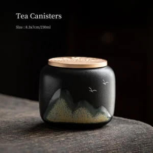 Close-up of black ceramic tea jar with Chinese landscape painting and gold metal lid