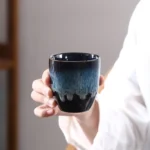 handcrafted blue jianzhan tea cup on wooden tea table