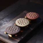 Handcrafted deep brown Yixing clay lotus seed pod tea pet on dark wooden tea tray, main product view