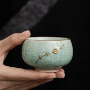 Full product view of handmade celadon crackle glaze chawan tea bowl with gold detailing