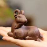 front view handcrafted yixing purple clay reclining goat tea pet