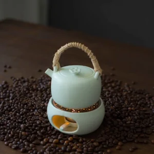 complete handmade ceramic teapot and candle warmer stove set in light green