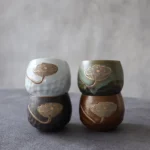 handmade embossed gold accent lotus porcelain tea cup full view