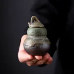 Full view of handmade gourd shaped ceramic tea jar