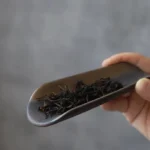 Handmade rustic vintage ceramic tea scoop on wooden tea table