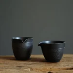 full product view of handmade textured black ceramic gong dao bei tea pitcher