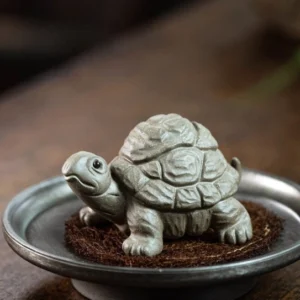 Handmade Yixing zisha turtle tea pet displayed on wooden tea table