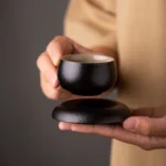 full view of 50ml japanese black clay tea cup with matching saucer