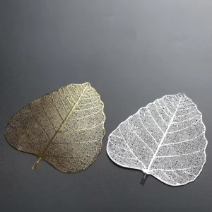 Leaf shape stainless steel loose leaf tea strainer placed over teacup