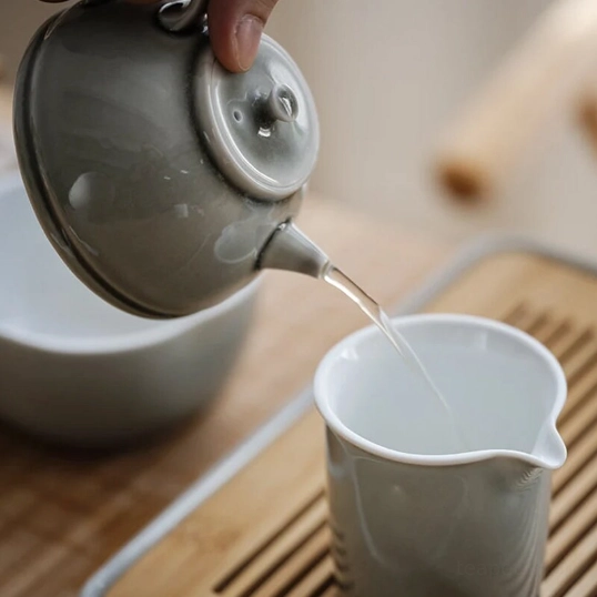 200ml light gray celadon ceramic teapot placed on wooden table