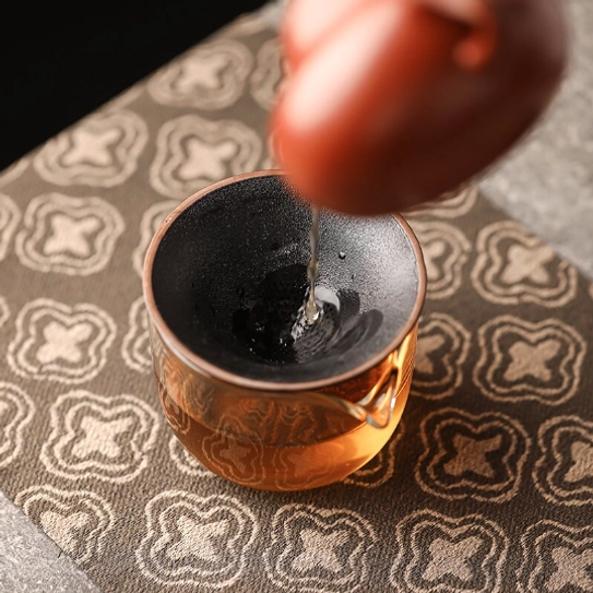 little monk tea strainer used to filter loose leaf tea into pitcher