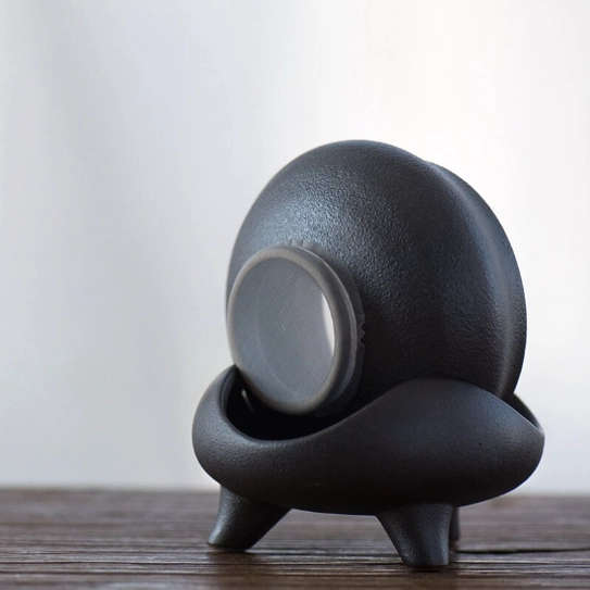 top view of matte black ceramic loose leaf tea strainer showing mesh filter