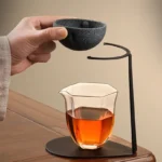 porous loose leaf tea strainer with black metal stand full view