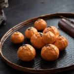 Lucky realistic orange ceramic tea pet on bamboo tea tray with teaware