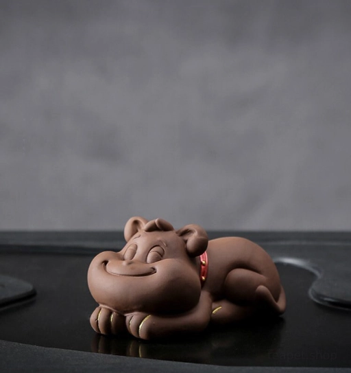 Cute lying French bulldog puppy zisha tea pet on black tea tray