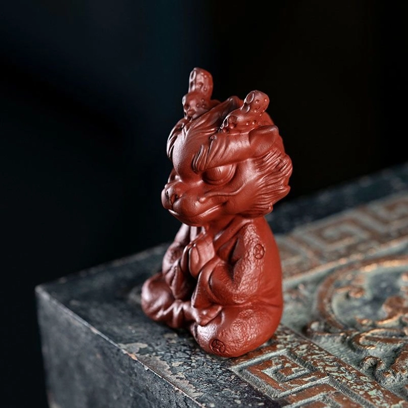 close up of hand carved details on meditating dragon tea pet face