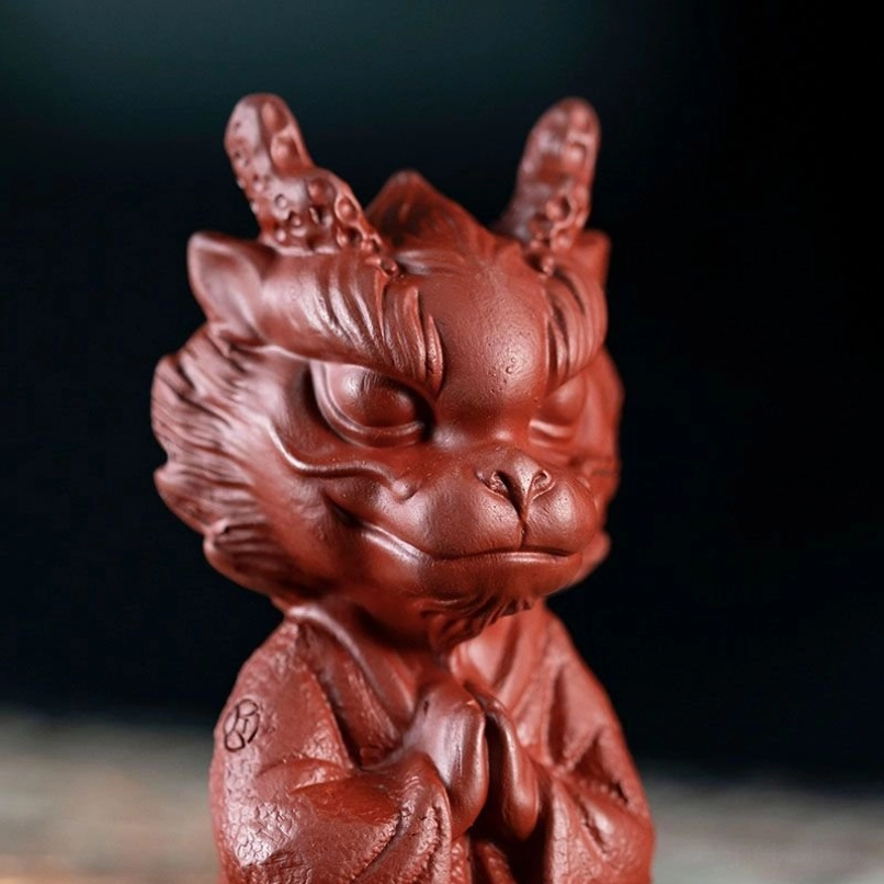 meditating dragon tea pet displayed on traditional tea tray