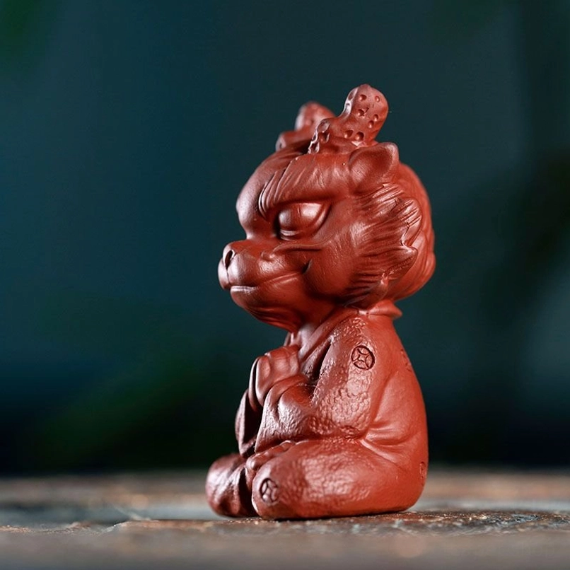 close up of clay texture and robe details on meditating dragon tea pet