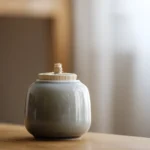 Mini handcrafted ceramic tea jar with woven bamboo lid full view