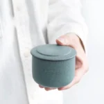 handheld mini green ceramic tea jar front view