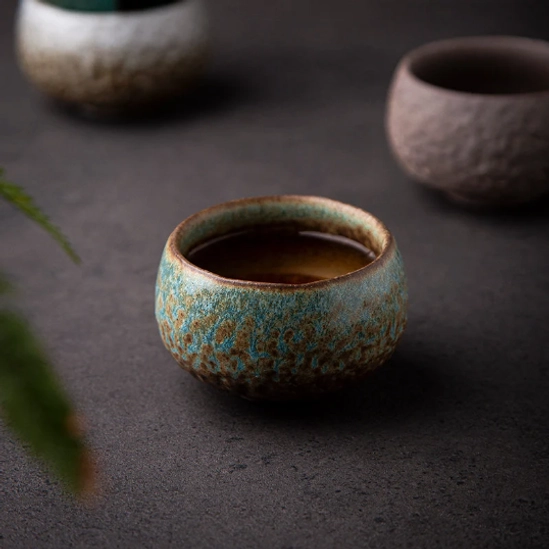 Natural kiln change glaze detail on rustic ceramic chawan tea bowl