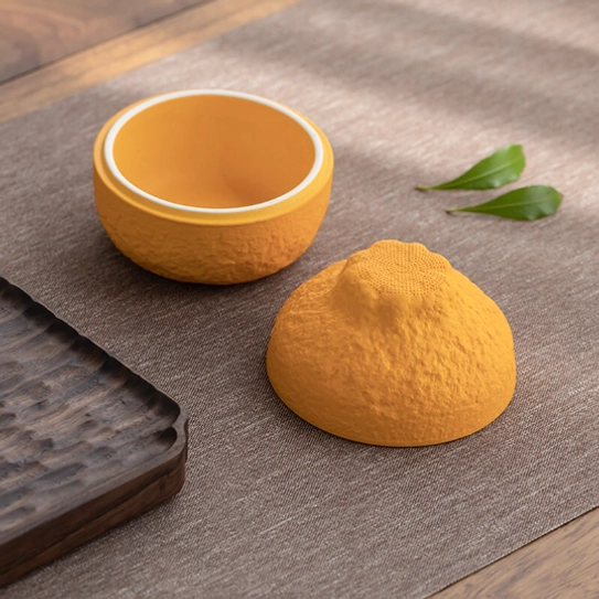 ceramic orange tea strainer top view showing filter holes