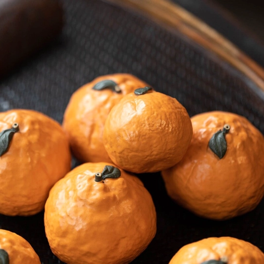 Orange tea pet as gongfu tea table decor on bamboo tea tray