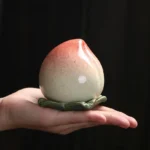 Peach shaped ceramic tea jar front view