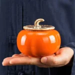 Persimmon shaped ceramic tea jar front view