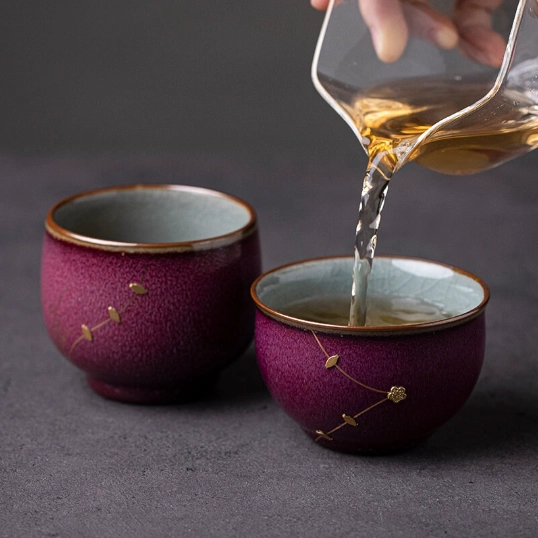 pouring hot tea into purple kintsugi gongfu tea cup
