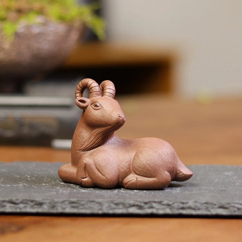 close up of hand carved horn details on purple clay goat tea pet