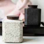 Full view of rustic ceramic tea jar with wooden lid