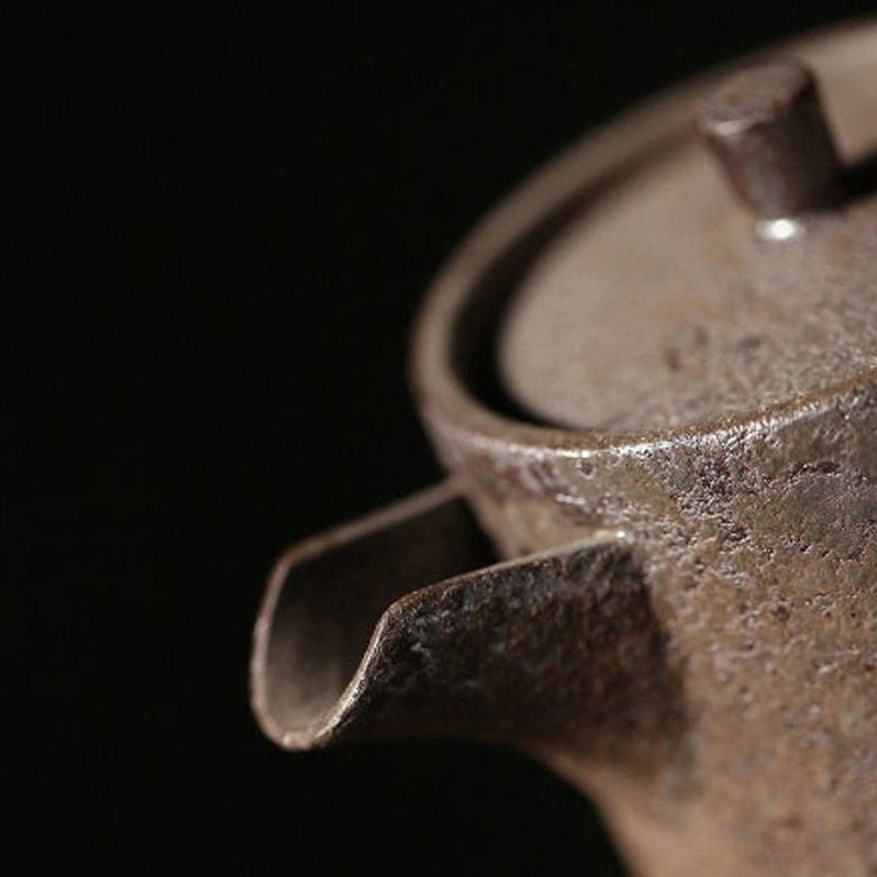 spout view of rustic iron rust glaze small ceramic tea pot