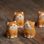 Set of 2 hand-carved solid wood orange cat tea pets main product view