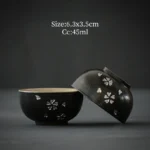 set of two handcrafted antique black ceramic chawan tea bowls with silver sakura inlay