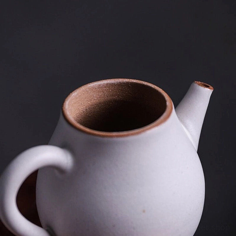 side view of 90ml compact white ceramic teapot with brown trim