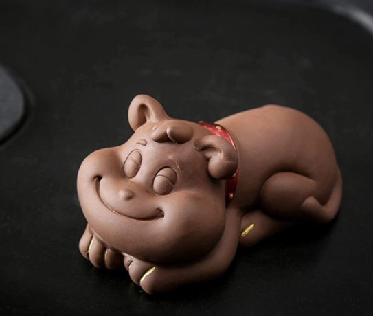 Side view of lying French bulldog puppy zisha tea pet