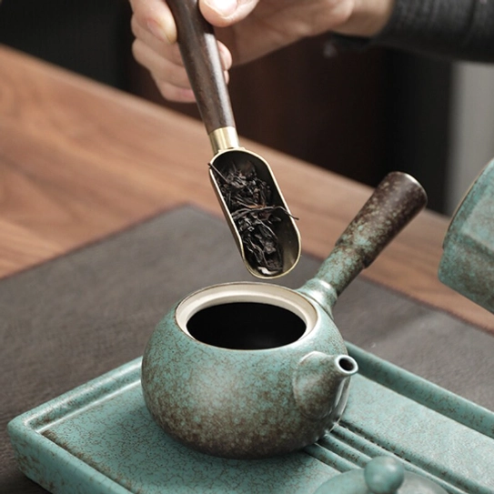 Vintage green Kyusu Teapot on neutral background side view