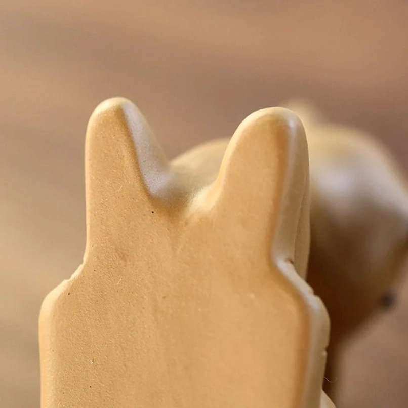 Sika deer tea pet displayed with tea utensils on a wooden tea tray for traditional tea ritual