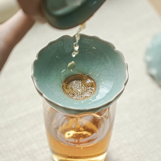 size comparison of ceramic lotus loose leaf tea strainer with a ruler