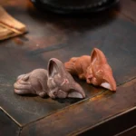 Brown handcrafted sleeping fox zisha tea pet on wooden Gongfu tea tray