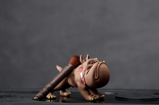 Standing French bulldog tea pet used as tea brush holder on a tea tray