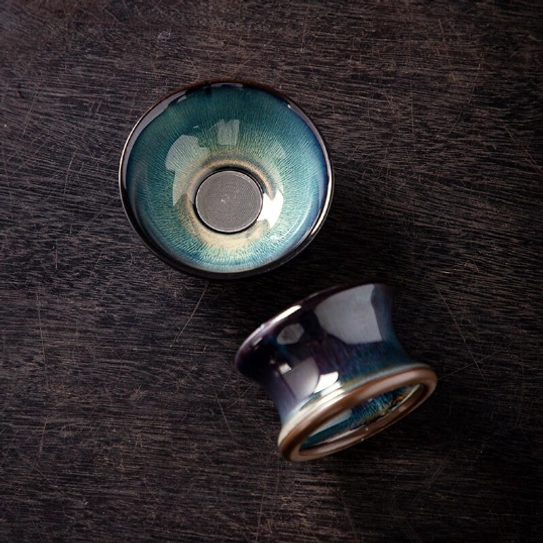 close up of the unique kiln transformation glaze on jian ware tea strainer