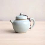 Style A light green Chinese ceramic teapot with built in infuser front view