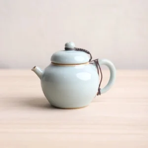 Style A light green Chinese ceramic teapot with built in infuser front view